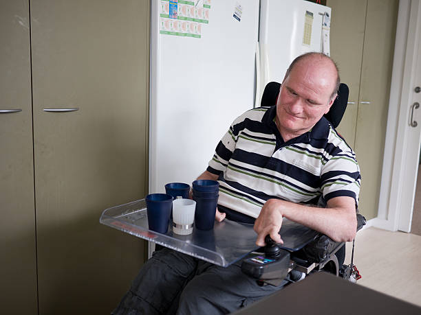istock Fifty-six-year-old man taking cups to dining table 471291623
