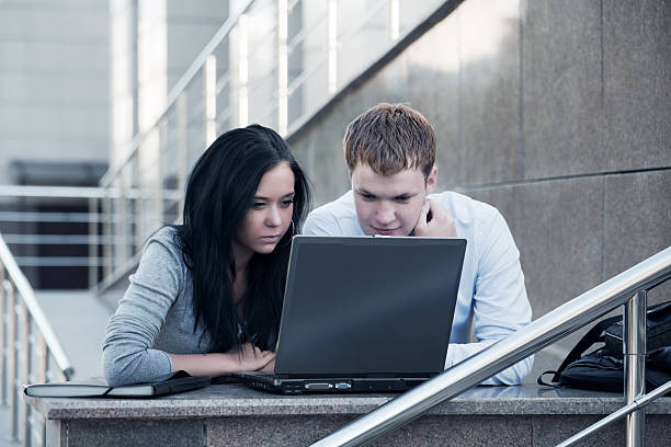 Young couple working on laptop stock photo