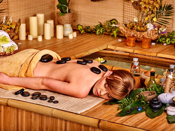 istock Woman getting stone therapy massage 471292226
