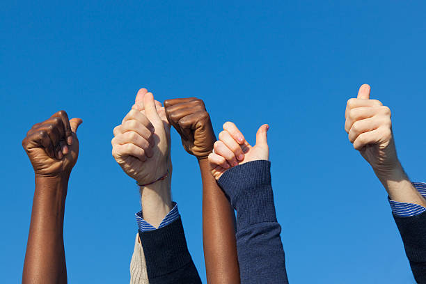 istock Multiracial Thumbs Up Against Blue Sky 471293005