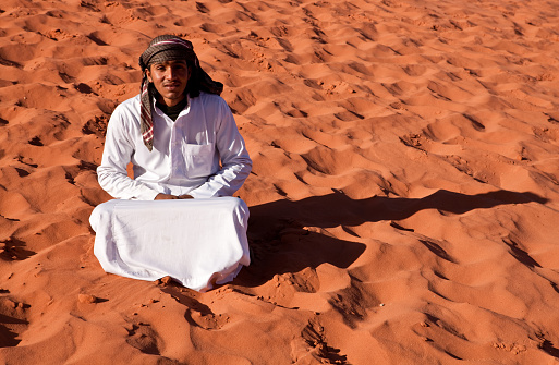 Bedouin is posing at the desert in Wadi Rum,Jordan.