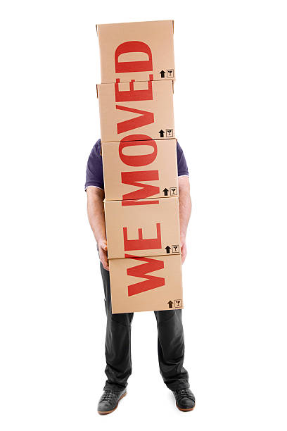 istock Man carrying boxes with a big  sign across them 471293765