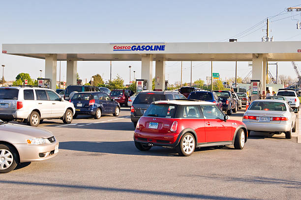 Several lines of cars at busy gas station stock photo