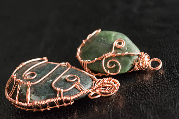 istock Two pendents of handwork against a dark background 471295862