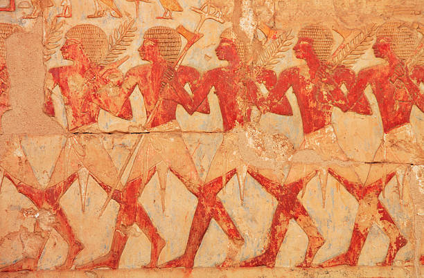 Egyptian Farmers Hieroglyphics Hieroglyphics depicting farmers during harvest, carrying pitchforks and barley crops. ancient egypt stock pictures, royalty-free photos & images