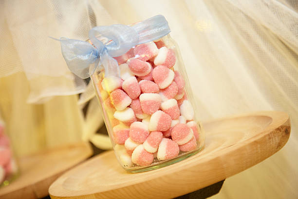 istock Glass jar with pink and white jelly beans inside 471296124