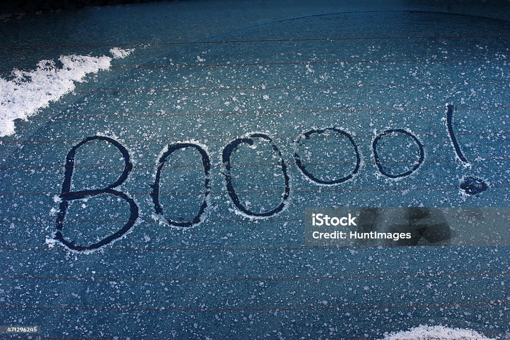Booo Winter The word "Booooo!" written across an ice and snow covered car window. Anger Stock Photo
