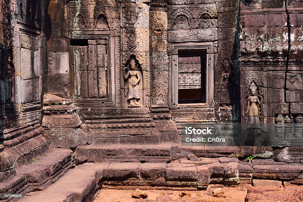 Apsara and Bas Relief by the window in Angkor Wat Apsaras and bass relief decorated a wall in Banteay Kdei, Angkor Wat, Siem Reap, Cambodia. 2015 Stock Photo