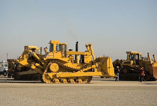 Track drive gear, bulldozer sprocket mechanism, large yellow construction machine with bolts, heavy industry, detail