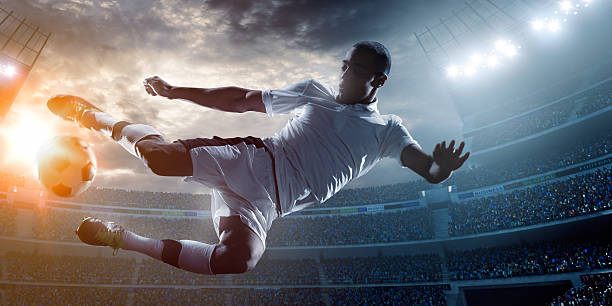 istock Soccer player kicking ball in stadium 471298866