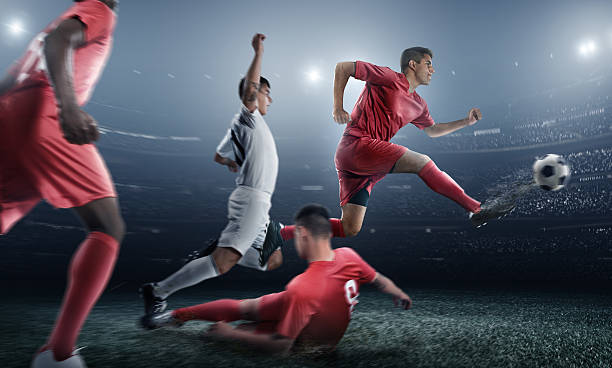 istock Soccer player kicking ball in stadium 471298872