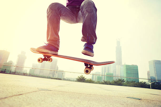 istock skateboarding legs doing ollie at city 471299072