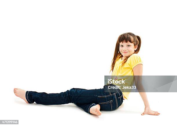 Pretty Little Girl Lying On The Floor In Jeans Stock Photo - Download Image Now - Cut Out, Girls, Playful