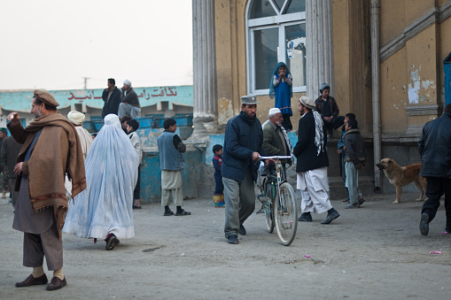 Kabul, Afghanistan - December, 13 2008: A policeman walking with his bicycle near Kabul river