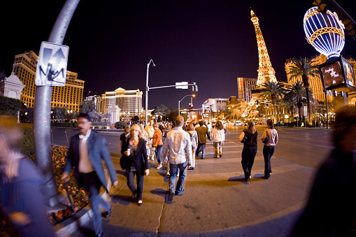 Las Vegas, Nevada, USA - March, 15 2009: people crossing the road by night, in front of the Bellagio and Paris Las Vegas Casinos.