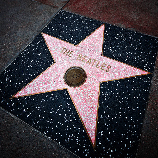 The Beatles, Walk of Fame, Hollywood Hollywood, California, USA - March 11, 2009:  The Beatles's Walk Of Fame star on Hollywood Boulevard. Sidewalk of stars stretches throughout Hollywood with over 2,000 celebrity names on in marble and brass. beatles stock pictures, royalty-free photos & images