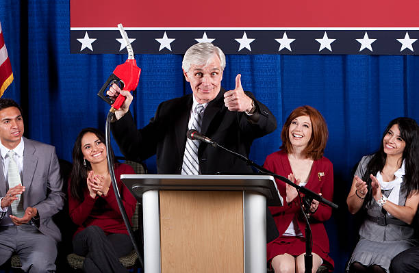 istock Politician at Podium With Fuel Pump Nozzle 471300573