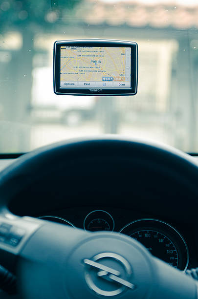 TomTom navigator inside a Opel car Florence, Italy - March 19, 2011: Tom Tom XXL (Europe Version) inside an Opel Zafira car. The gps navigator show the Paris Map. TomTom is a Dutch company that makes satellite navigation systems for automobiles, motorcycles, handhelds and smartphones. It is the leading supplier of navigation systems in Europe with offices around the world. guidanc stock pictures, royalty-free photos & images