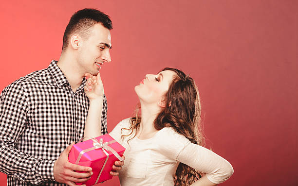 istock happy romantic couple with gift 471304162