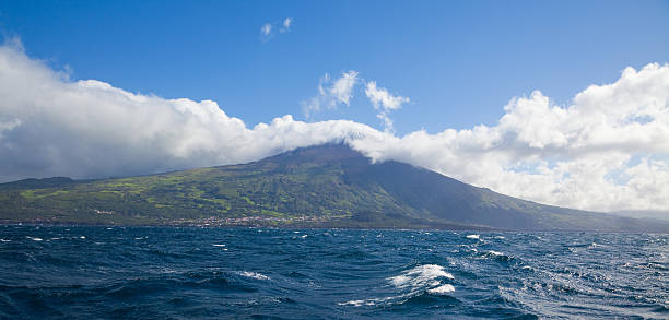 Island of Pico View towards the Volcano Pico, Portugal's highest mountain, from the Atlantic Sea. Archipelago of the Azores. madalena stock pictures, royalty-free photos & images