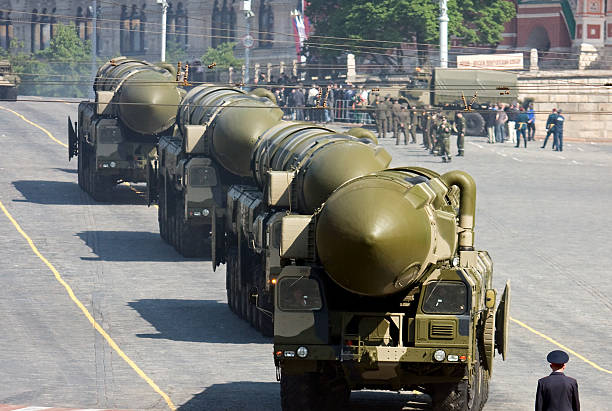 Russian nuclear missiles "Topol-M" in military parade, Moscow Moscow, Russia - May 5, 2008: Russian policeman stands in front of convoy of nuclear missiles &amp;quot;Topol-M&amp;quot; in military parade rehearsal on Red Square, Moscow nuclear weapon stock pictures, royalty-free photos & images