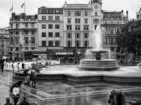 London, United Kingdom - 7th may 2011: Trafalgar Square is a public space and tourist attraction in central London, the square with a gathering of nuns in the rain in the afternoon.