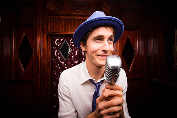 A lounge singer or comedian with a retro microphone on stage at a seedy dive bar adorned in red leather and wood paneling