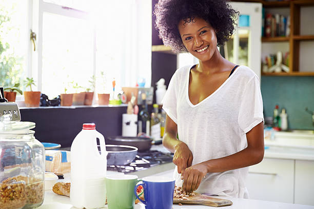 istock Young Woman Wearing Pajamas Preparing Breakfast In Kitchen 471311246
