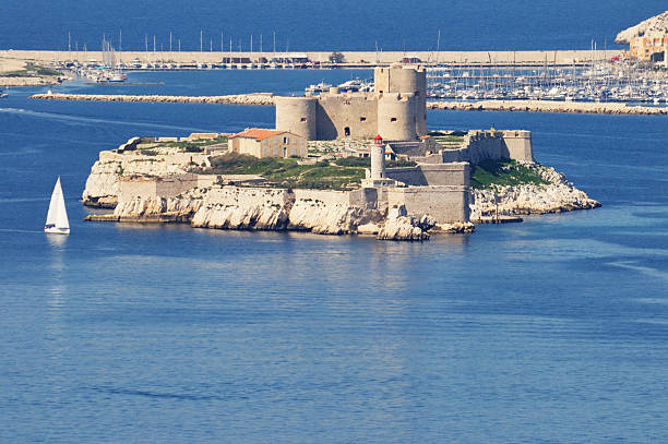 Chateau d'If, Marseille, France Marseille, France - April 13, 2010: Chateau d'If, Marseille, France, viewed from the Corniche (Coast Road). Built in the 16th century, the Ch&amp;amp;Atilde;&amp;amp;cent;teau d'If is a fortress (later a prison) located on the island of If, the smallest island in the Frioul Archipelago situated in the Mediterranean Sea about a mile offshore in the Bay of Marseille in southeastern France. It is famous for being one of the settings of Alexandre Dumas' adventure novel The Count of Monte Cristo.The ch&amp;amp;Atilde;&amp;amp;cent;teau is a square, three-storey building 28 m long on each side, flanked by three towers with large gun embrasures. The remainder of the island, which only measures 30,000 square metres, is heavily fortified; high ramparts with gun platforms surmount the island's cliffs. frioul archipelago stock pictures, royalty-free photos & images