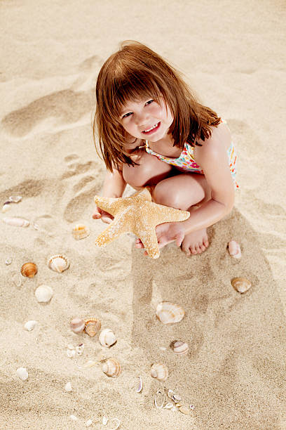 istock Little girl on the tropical send beach 471312465