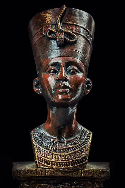 Queen Nefertiti replica souvenir isolated on black.