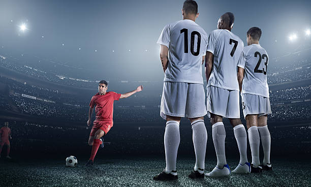 istock Soccer player kicking ball in stadium 471314294
