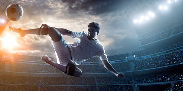 istock A football player doing a in air kick in a stadium 471314338