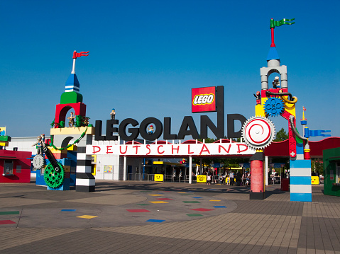 Guenzburg, Germany - May 13, 2011: Entrance of Legoland. Legoland is a chain of Lego themed theme parks owned by Merlin Entertainment. People can be seen in the distance.