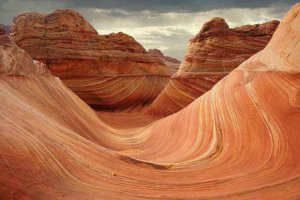 The Wave at North Coyote Buttes The incredible swirling sandstone formations at "The Wave" at north Coyote Buttes in Utah/Arizona. doing the wave stock pictures, royalty-free photos & images
