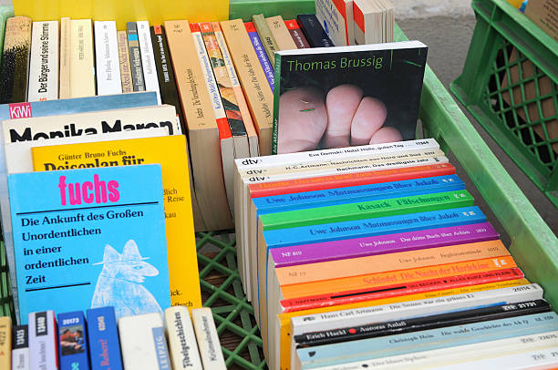 Berlin, Germany - August 3, 2011: used bookstore at Berlin Kreuzberg (Germany) at Bergmannstrasse. in front old second hand book waiting for buyers like Fairytales und a book with a big toe on cover. Its a touristical magnet of multi-culture.