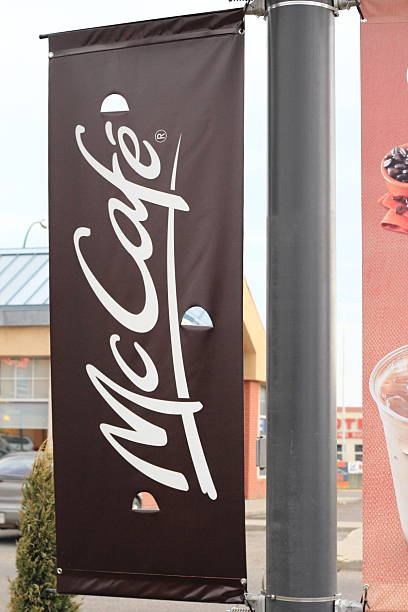 Lethbridge, Canada - July 13, 2011: McDonald's hanging pole sign advertising for McCafe.  McCaf&eacute; was created and started in Melbourne, Australia in 1993, and has expanded around the world.  It offers coffee-house-style food and espresso.  It is owned by McDonald's.