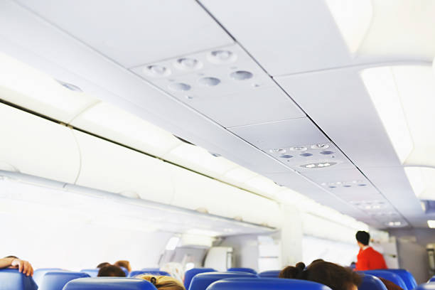 istock Interior of airplane with passengers on seats. 471318762