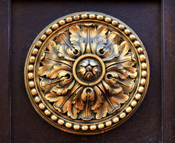 Art Noveau style architectural detail of large gold ornament.