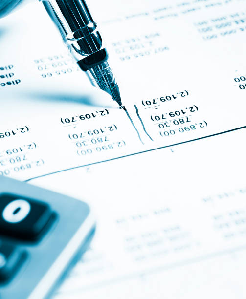 istock Blue-tinted image of pen, spreadsheet and calculator checking financial statement 471319713