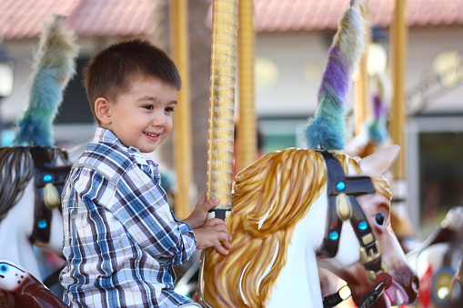 Child Having Fun on the Carousel