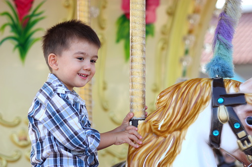Child Having Fun on the Carousel.