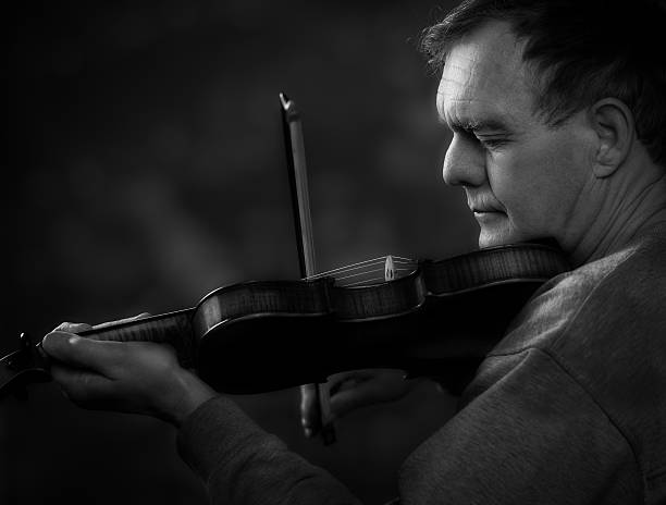 istock Senior Man Playing a Violin or Fiddle, black and white. 471322488