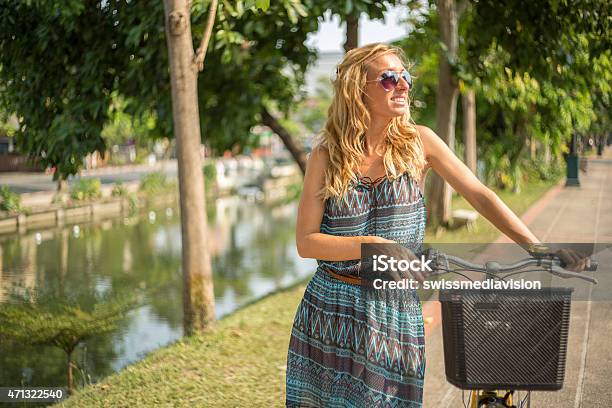 Blond Hair Woman With Bicycle Enjoying Nature Stock Photo - Download Image Now - 20-24 Years, 2015, 25-29 Years
