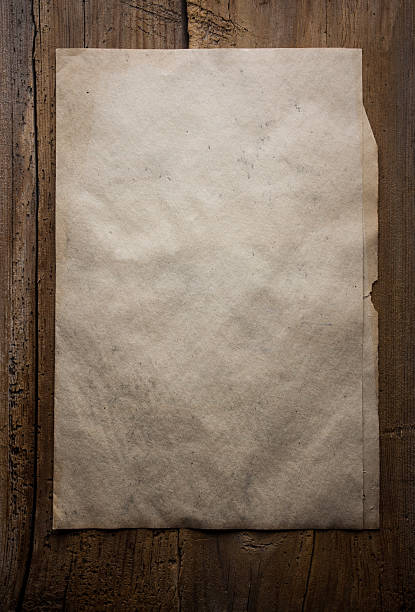 istock paper on wooden background 471325500
