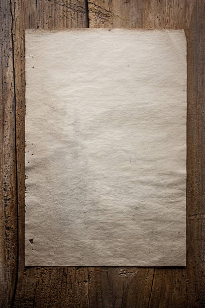 istock paper on wooden background 471325502