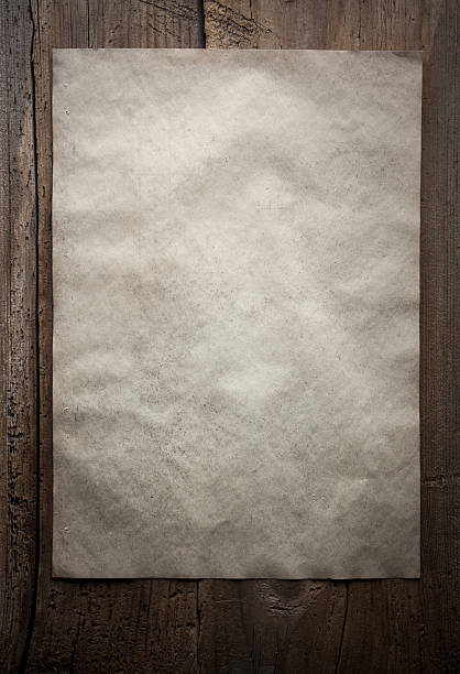 istock paper on wooden background 471325512