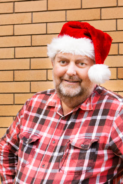 istock Mature man in santa hat 471325731