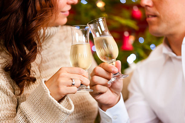 istock Couple with champagne on Christmas Eve 471325891