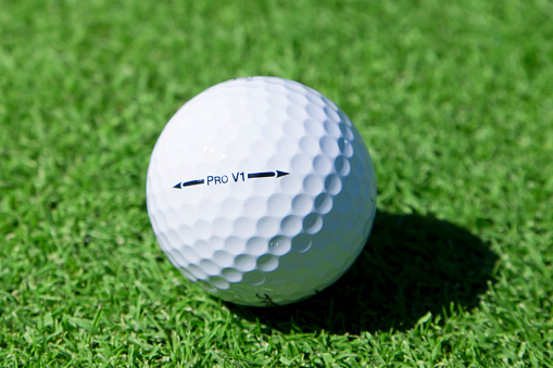 Nashville, Tennessee, USA - September 26th, 2011: A close up of a Titleist Pro V1 golf ball on a golf green inches from the hole in Nashville TN.
